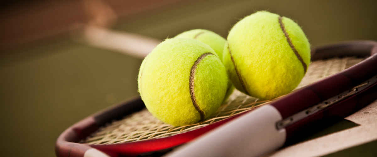 A tennis racket and balls